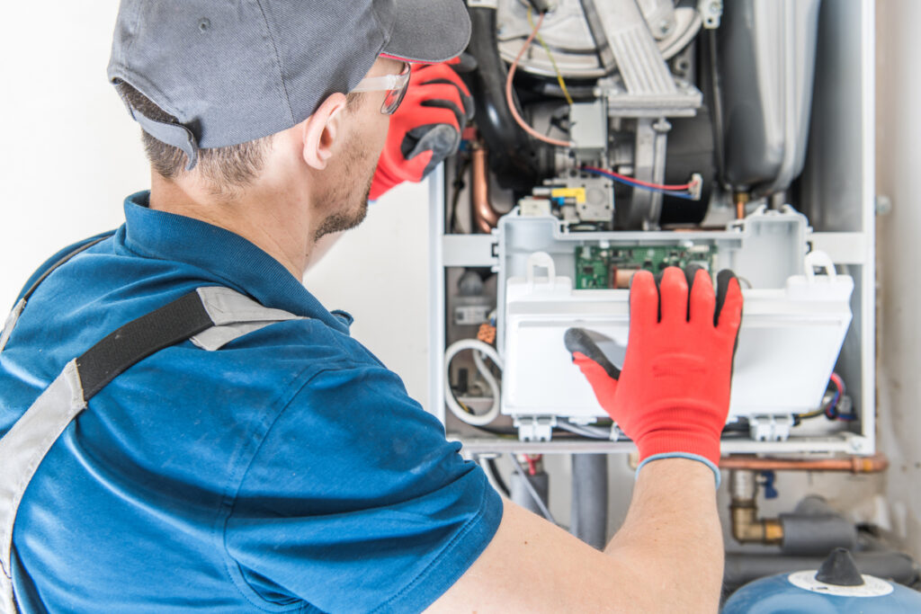 HVAC technician repairing a residential furnace